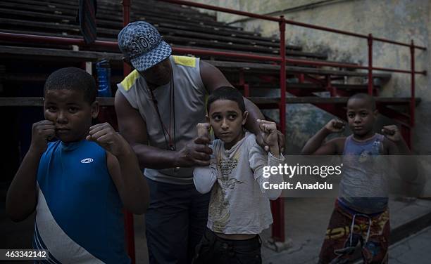 Year old Alberto Gonzales , working as a coach for 25 years, trains the kids near boxing ring at a training hall in Havana capital of Cuba on...