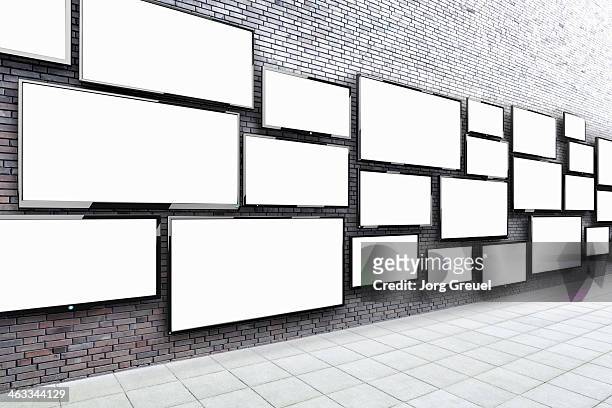 flat screens hanging on a wall - tv on wall stockfoto's en -beelden
