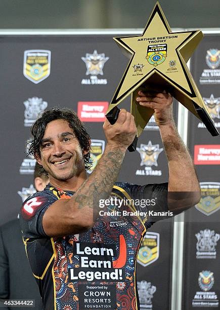 Johnathan Thurston of the Indigenous All Stars holds up the winners trophy after the NRL pre-season match between the Indigenous All Stars and the...