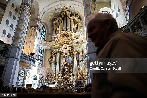 Visitors look at the Frauenkirche before the commemoration of the 70th anniversary of the Allied firebombing of Dresden on February 13, 2015 in...