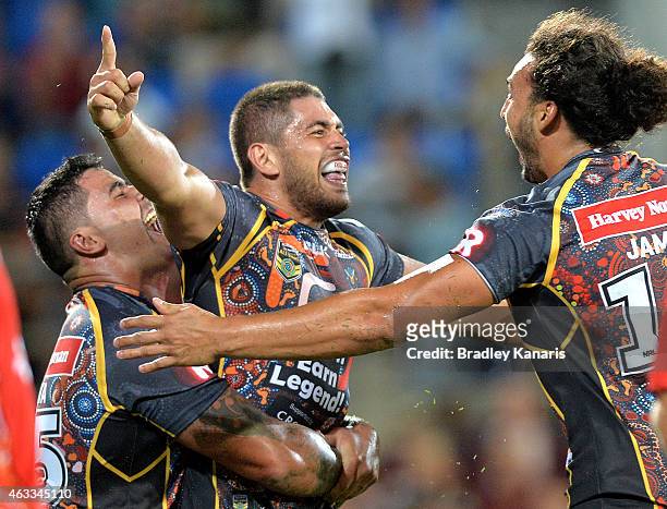 Chris Grevsmuhl of the Indigenous All Stars celebrates with team mates after scoring a try during the NRL pre-season match between the Indigenous All...