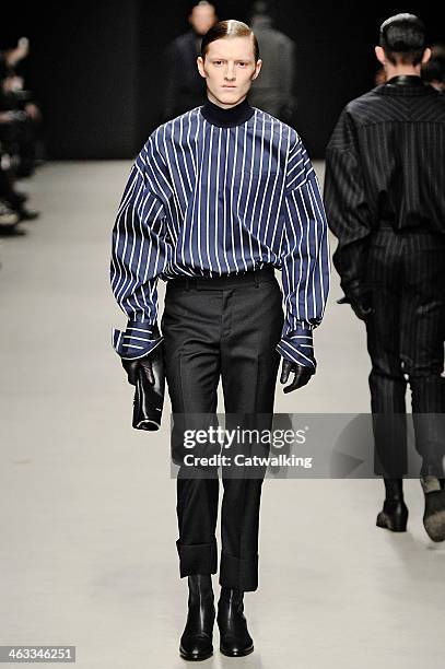 Model walks the runway at the Juun.J Autumn Winter 2014 fashion show during Paris Menswear Fashion Week on January 17, 2014 in Paris, France.