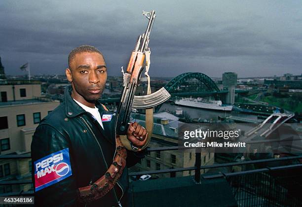 Newcastle United striker Andy Cole pictured holding a gun on a sponsors shoot overlooking the city of Newcastle on January 26, 1994 in Newcastle Upon...