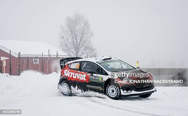 Henning Solberg of Norway and his co-driver Ilka Minor of Austria steer their Ford Fiesta WRC during the 3rd stage of the Rally Sweden, second round...