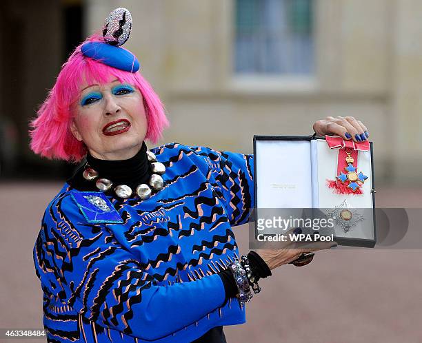 Fashion designer Zandra Rhodes holds her Dame Commander of the Order of the British Empire medal presented to her by the Princess Royal at an...