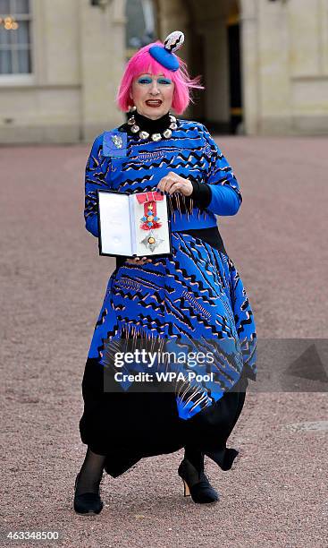 Fashion designer Zandra Rhodes holds her Dame Commander of the Order of the British Empire medal presented to her by the Princess Royal at an...