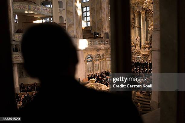 Visitor watches a ceremony in Frauenkirche during the commemoration of the 70th anniversary of the Allied firebombing of Dresden on February 13, 2015...