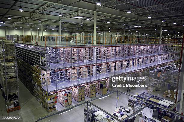 Storage racks containing retail goods stand in the distribution center of online fashion retailer KupiVIP in Klimovsk, Russia, on Friday, Feb. 13,...