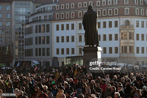 People gather outside to watch a ceremony in Frauenkirche on a live screen during the commemoration of the 70th anniversary of the Allied firebombing...