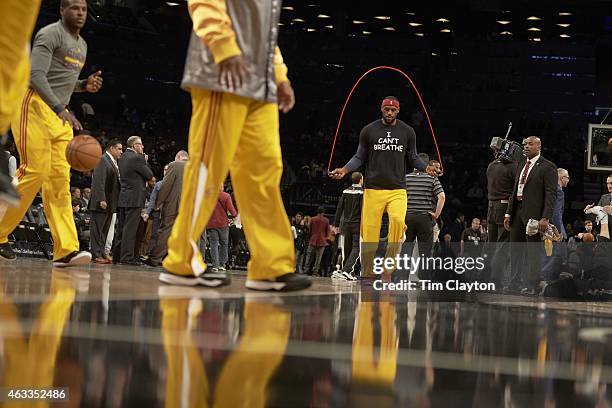 Cleveland Cavaliers LeBron James warms up on court before game vs Brooklyn Nets at Barclays Center. LeBron James wearing shirt reading I CAN'T...