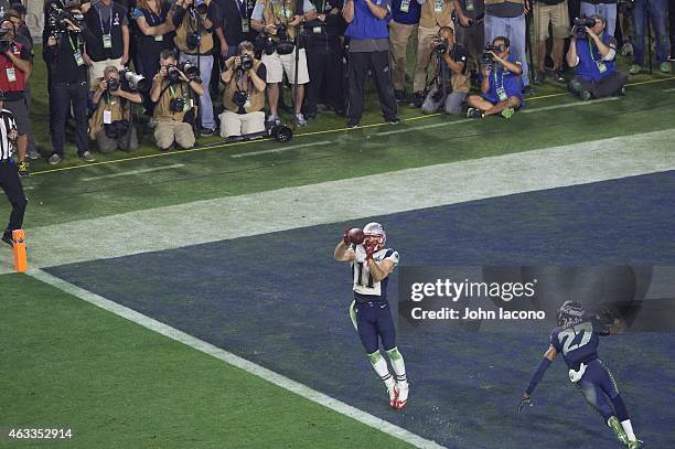 Super Bowl XLIX: New England Patriots Julian Edelman in action, making catch in endzone for touchdown vs Seattle Seahawks Tharold Simon at University...