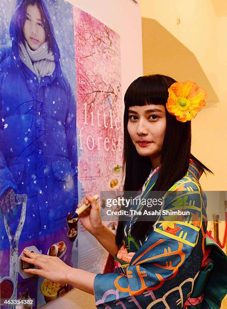 Actress Ai Hashimoto signs autograph during a stage greeting at the 'Little Forest': Culinary Cinema during the 65th Berlinale International Film...