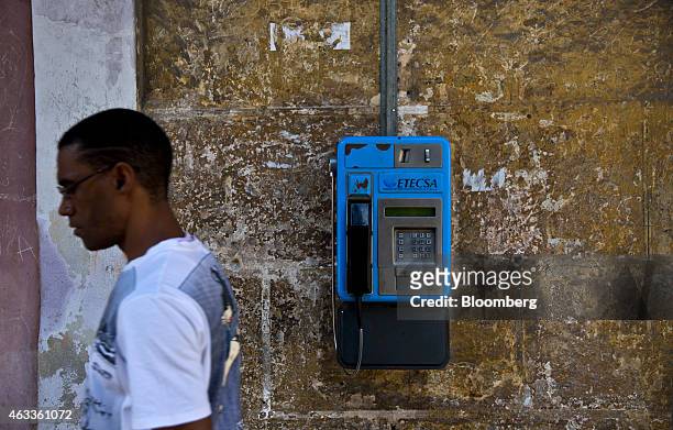 Man walks past an Empresa de Telecomunicaciones de Cuba SA public telephone in Havana, Cuba, on Saturday, Jan. 31, 2015. U.S. Companies will be...