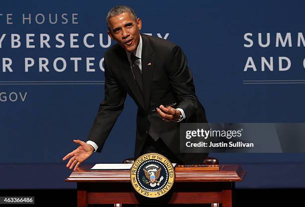 President Barack Obama pauses as he signs an executive order during the White House Summit on Cybersecurity and Consumer Protection on February 13,...