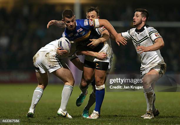 Tom Briscoe of Leeds Rhinos crashes into Cameron Phelps and Danny Craven of Widnes Vikings during the First Utility Super League match between Leeds...