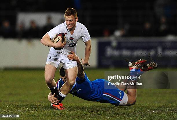 Rory Jennings of England is tackled by Dennis Bergamin of Italy during the U20s Six Nations match between England U20 and Italy U20 at Brickfields on...