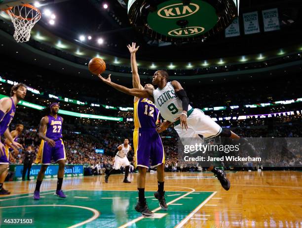 Rajon Rondo of the Boston Celtics is midair for a layup in front of Kendall Marshall of the Los Angeles Lakers in the second quarter during the game...