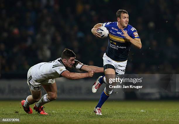 Danny McGuire of Leeds Rhinos breaks through the tackle of Chris Clarkson of Widnes Vikings during the First Utility Super League match between Leeds...