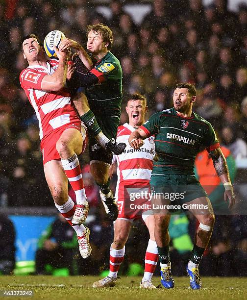 Mark Atkinson of Gloucester Rugby jumps for the ball with Matthew Tait of Leicester during the Aviva Premiership match between Leicester Tigers and...