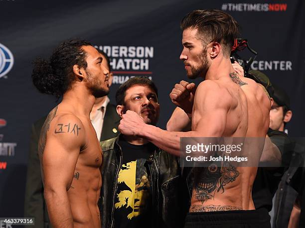 Opponents Benson Henderson and Brandon Thatch face off during the UFC weigh-in at the 1stBank Center on February 13, 2015 in Broomfield, Colorado.