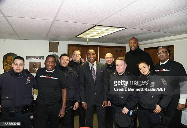 Isiah Thomas Alonzo Mourning and Reverend Thomas Johnson pose for a picture with members of the NYPD during NBAPA All-Star Youth Summit: Real Talk on...
