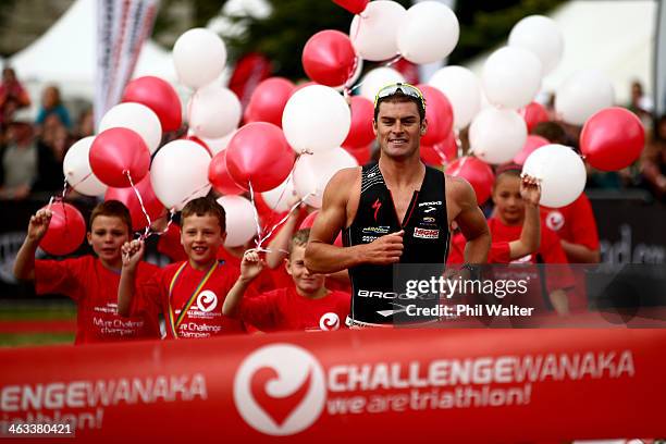 Dylan McNeice of New Zealand crosses the finish line to win the Challenge Wanaka on January 18, 2014 in Wanaka, New Zealand.