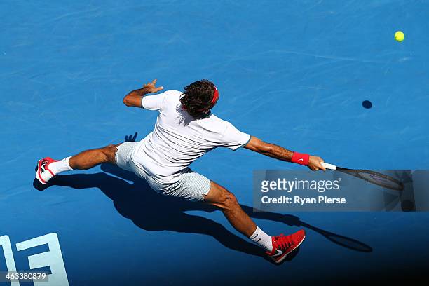 Roger Federer of Switzerland plays a forehand in his third round match against Teymuraz Gabashvili of Russia during day six of the 2014 Australian...