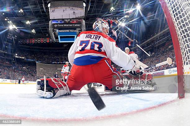 Goaltender Braden Holtby of the Washington Capitals fails to stop a shot taken by Cam Atkinson of the Columbus Blue Jackets during the third period...