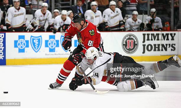 Cam Fowler of the Anaheim Ducks tries to take down Marian Hossa of the Chicago Blackhawks as Hossa moves to score and empty net goal late in the...