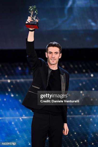 Italian singer Giovanni Caccamo, winner of the 65th Italian Music Festival in Sanremo, poses with his trophy at the Ariston theatre during the Fourth...