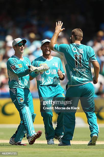 Craig Kieswetter of the Heat celebrates with teammate Daniel Vettori after getting the wicket of Jono Dean of the Strikers during the Big Bash League...
