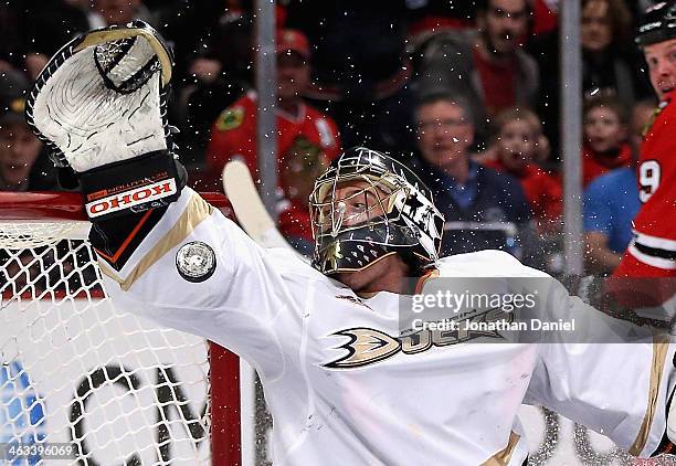 Jonas Hiller of the Anaheim Ducks tries to make a save on a goal shot by Bryan Bickell of the Chicago Blackhawks at the United Center on January 17,...