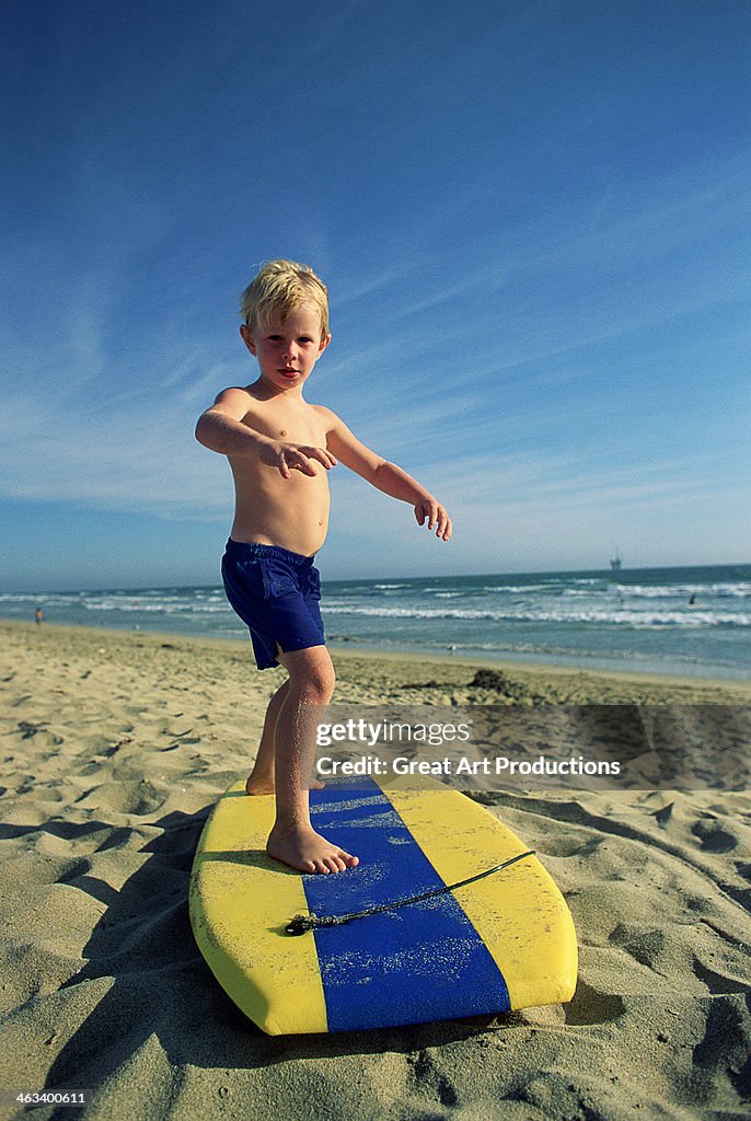 Little Surfer rides the sand