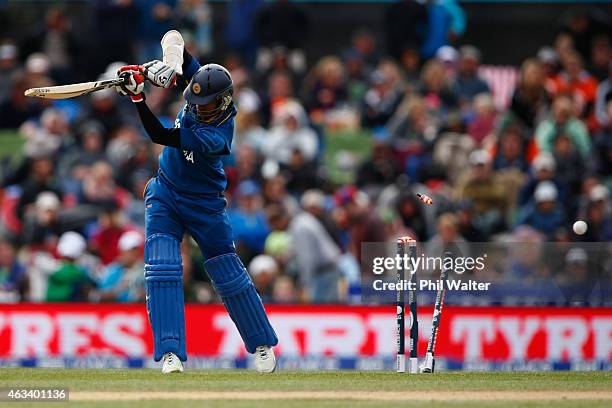 Dimuth Karunaratne of Sri Lanka is bowled by Adam Milne of New Zealand during the 2015 ICC Cricket World Cup match between Sri Lanka and New Zealand...