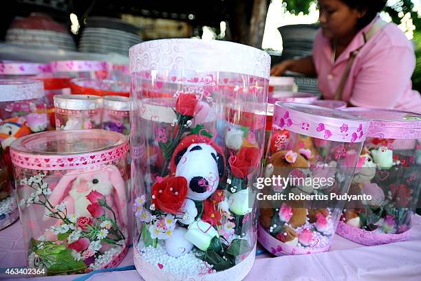 Vendor sets up toys during Valentines Day on February 14, 2015 in Surabaya, Indonesia. Roses, chocolates, teddy bears, toy hearts, candles, and cards...