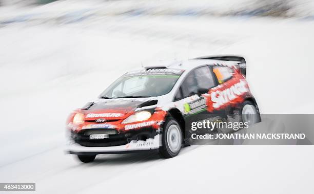 Henning Solberg of Norway and his co-driver Ilka Minor of Austria steer their Ford Fiesta WRC during the 13th stage of the Rally Sweden, second round...