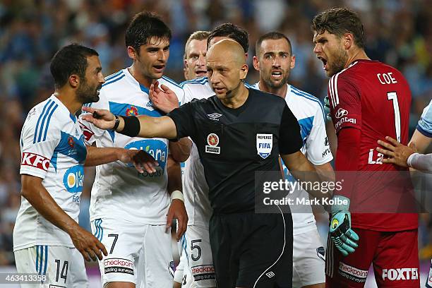 Fahid Ben Khalfallah, Gui Finkler, Besart Berisha, Mark Milligan Carl Valeri and Nathan Coe of Melbourne Victory argue with referee Strebre Dilovski...