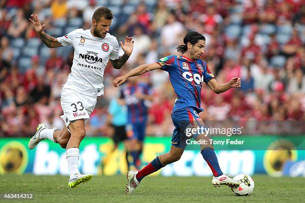 Zenon Caravella of the Jets controls the ball in front of Nicholas Kalmar of the Wanderers during the round 17 A-League match between the Newcastle...