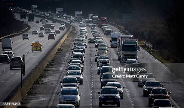 Traffic backs up behind a convoy transporting the fuselage and other parts of a Boeing 747 along the M4 motorway on February 14, 2015 near Bristol,...