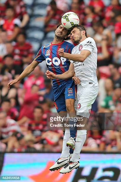 Zenon Caravella of the Jets contests a header with Mateo Poljak of the Wanderers during the round 17 A-League match between the Newcastle Jets and...