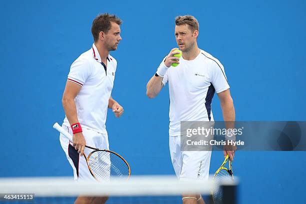 Johan Brunstrom of Sweden and Frederik Nielsen of Denmark in action in their second round doubles match against Julien Benneteau of France and...