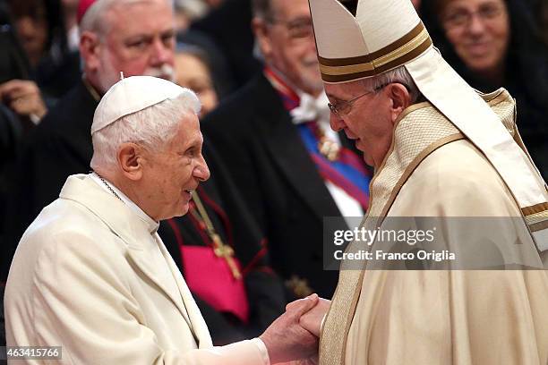 Pope Emeritus Benedict XVI is greeted by Pope Francis during the Ordinary Public Consistory at St. Peter's Basilica on February 14, 2015 in Vatican...