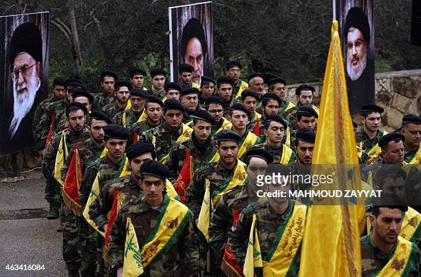 Lebanese Hezbollah fighters march near portraits of Iran's Supreme Leader Ayatollah Ali Khamenei , founder of Iran's Islamic Republic, late Ayatollah...