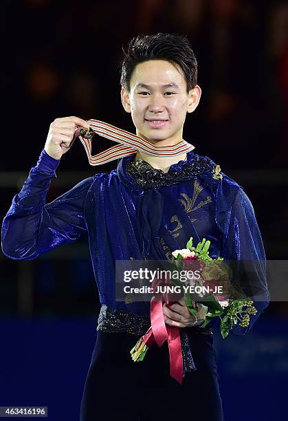 Gold medalist Denis Ten of Kazakhstan poses on the podium after the men's free skating during the ISU Four Continents Figure Skating Championships in...