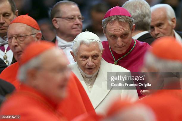 Pope Emeritus Benedict XVI, flanked by his former personal secretary and Prefect of the Pontifical House Georg Ganswein , greets cardinals during the...