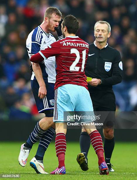 Morgan Amalfitano of West Ham United pushes Chris Brunt of West Bromwich Albion in the face and is then sent off by referee Martin Atkinson during...