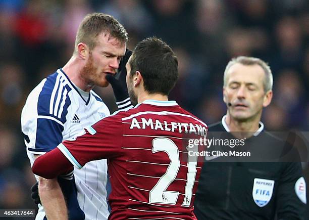 Morgan Amalfitano of West Ham United pushes Chris Brunt of West Bromwich Albion in the face and is then sent off by referee Martin Atkinson during...