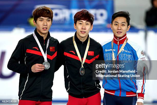 Gold medalist Tianyu Han of China , Silver medalist Chen Dequan of China and Victor An of Russia pose for a picture after winning the Men's 1500m A...