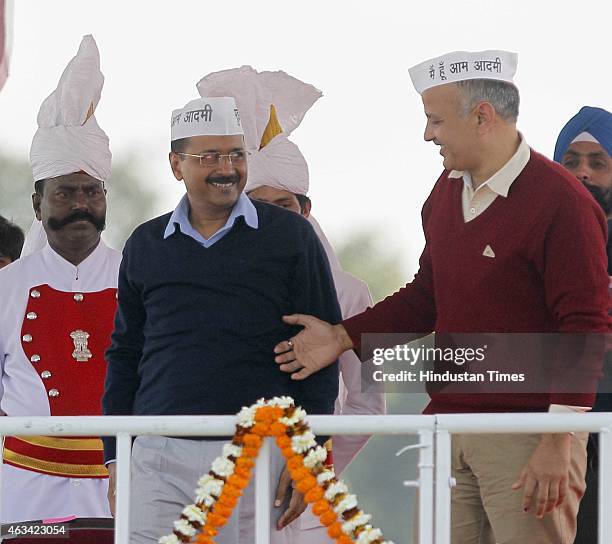 Newly appointed Delhi Chief Minister Arvind Kejriwal greeted by Manish Sisodia after their swearing-in ceremony at the Ramlila Ground on February 14,...