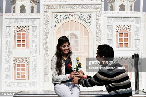 Lovers take selfies in front of the Taj Mahal shaped structure as they celebrated Valentine's Day, at The Great India Place mall on February 14, 2015...